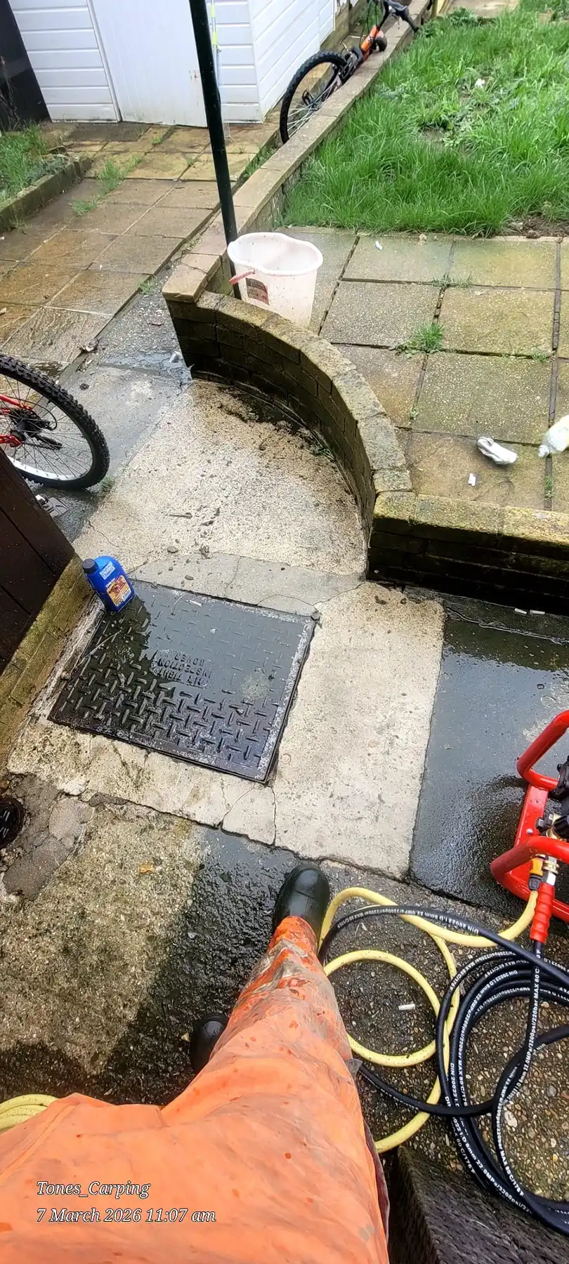 Drain cover with paving in need of repair.